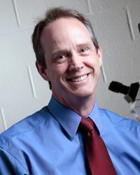 Headshot of John A. Pollock, smiling.