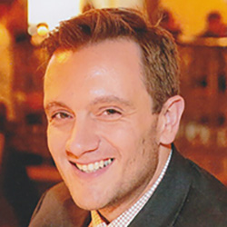 Profile picture of Chris McCulloh with short, light brown hair and wearing a suit, smiling.