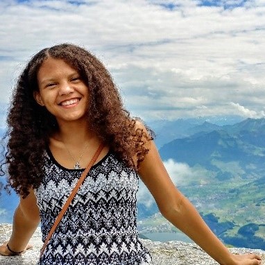 Bethanie Stauffer in front of a view of a mountainous landscape.