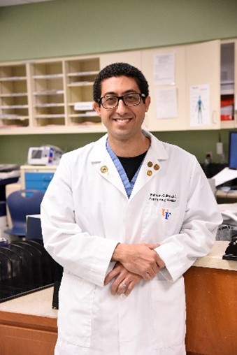 Dr. Guirgis in a white lab coat.