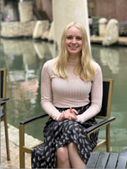 Anneka Johnson sitting in a chair in front of a pond.