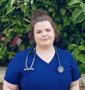A headshot of Carley Dearing in scrubs with a stethoscope around her neck.