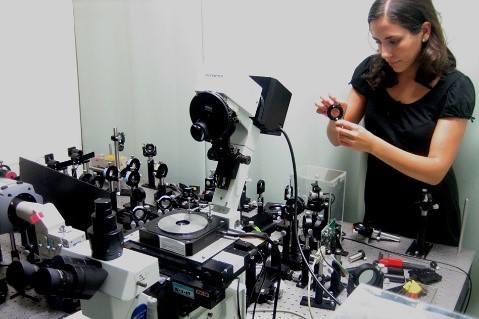 Dr. Landry behind a table full of scientific equipment.