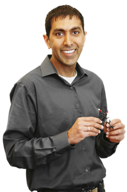 A picture of Dr. Garg holding a plastic model of a molecule.