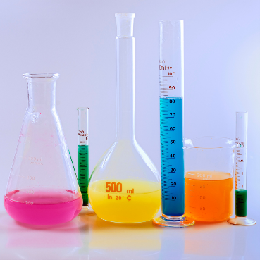 Various chemistry glassware filled with differently colored liquids.