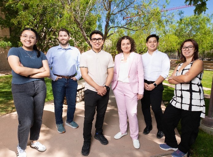 Dr. Eda Koculi and five other people standing outside.