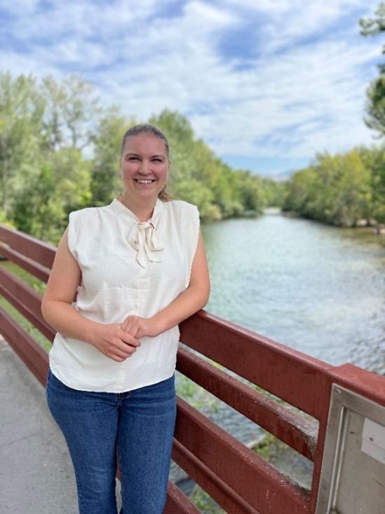 A portrait image of Haley Bridgewater standing on a bridge over a river.